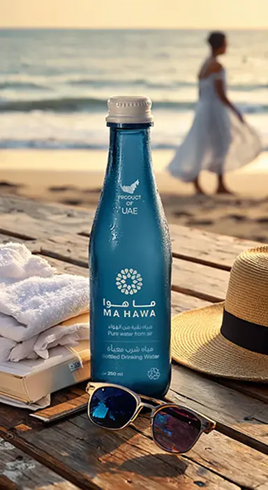 Ma Hawa glass water bottle on a beach at sunset